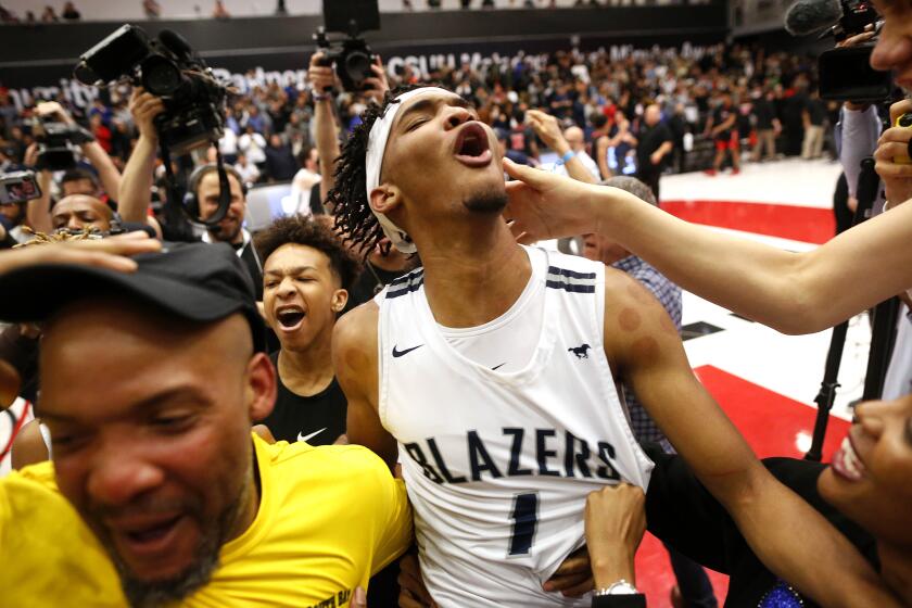 NORTHRIDGE, CALIF. -- TUESDAY, MARCH 10, 2020: Ziaire Williams (1) of Sierra Canyon celebrates with teammates and fans after making the game winning basket as time expires in the second half of the CIF Open Division regional basketball final game against Etiwanda played at the Matadome on the campus of California State University, Northridge in Northridge, Calif., on March 10, 2020. Sierra Canyon won 63-61 on Ziaire Williams (1) last second basket. (Gary Coronado / Los Angeles Times)
