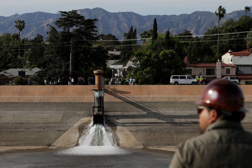 Water flows into the Silver Lake Reservoir Complex Tuesday, April 25, 2017, in Los Angeles. Two years after authorities drained the reservoirs in Los Angeles, the water is flowing in again. Officials on Tuesday began the process of refilling the 96-acre Silver Lake and Ivanhoe reservoirs, which once held drinking water and was a landmark in the arty, upscale neighborhood. (AP Photo/Jae C. Hong)