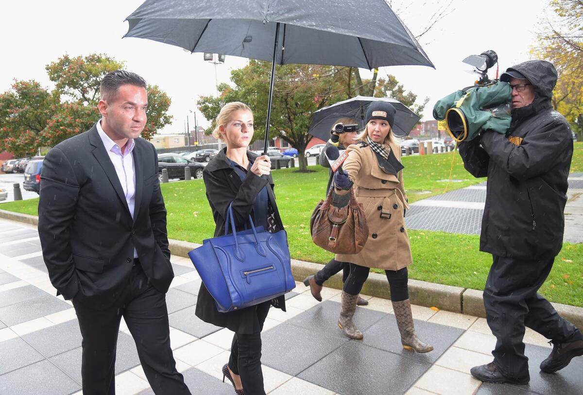 Mike "The Situation" Sorrentino and fiancee Lauren Pesce appear for Sorrentino's arraignment on tax fraud charges at the Martin Luther King Building and U.S. Courthouse on Oct. 23, 2014 in Newark.