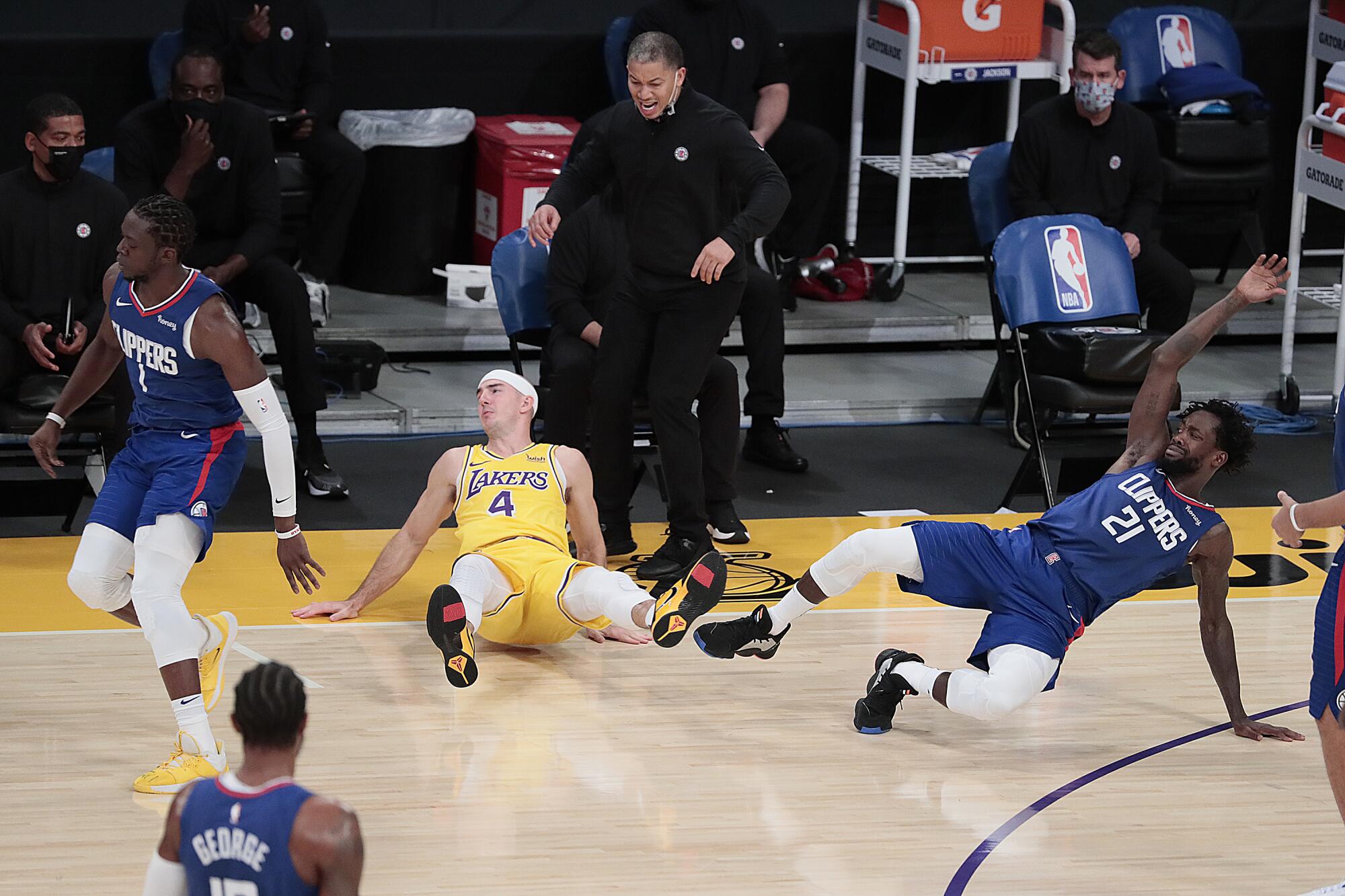 Clippers guard Patrick Beverley (21) collides with Lakers guard Alex Caruso (4) in front of Clippers coach Tyronn Lue.