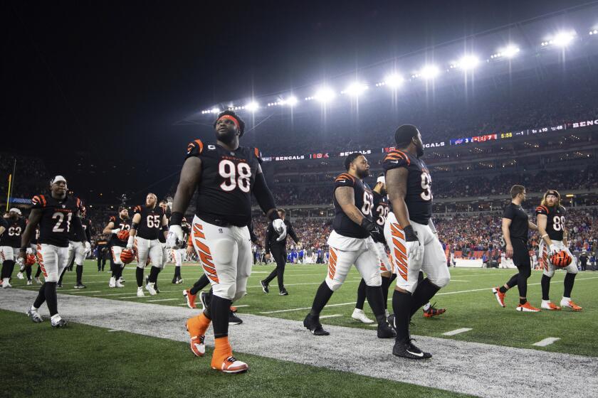 The Cincinnati Bengals walk off the field as the game is suspended after Buffalo Bills' Damar Hamlin is injured during the first half of an NFL football game, Monday, Jan. 2, 2023, in Cincinnati. (AP Photo/Emilee Chinn)