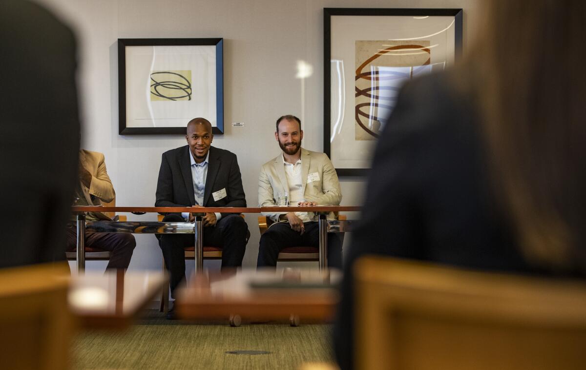 David West, left, and Ricky Volante, founders of an Historical Basketball League, speak at the AthletesTouch meeting.