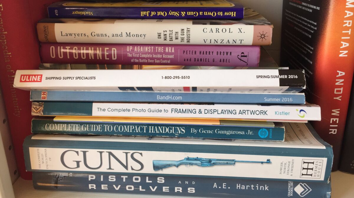 Books about guns on the shelves of Richard Ruggieri's home office.