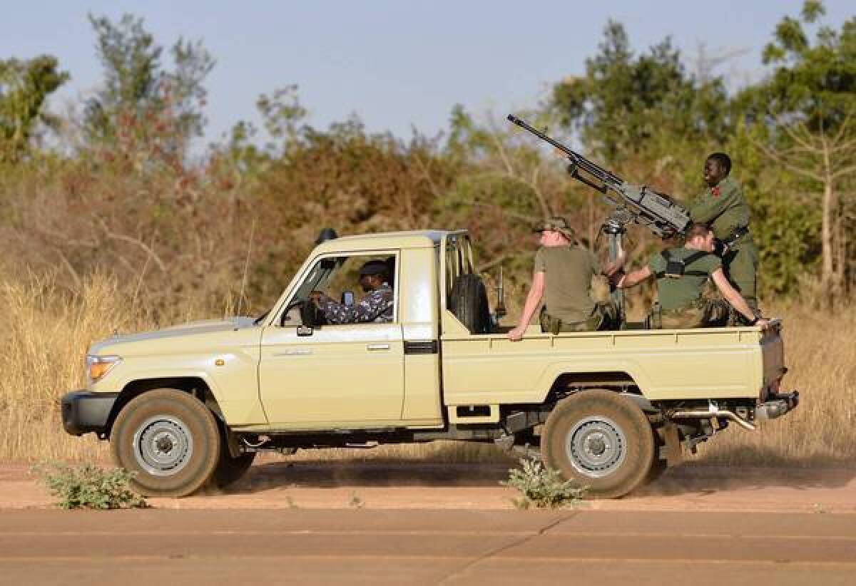 French soldiers deployed in an operation against Islamist militants in Mali ride in a military vehicle at an air base near Bamako, the capital.