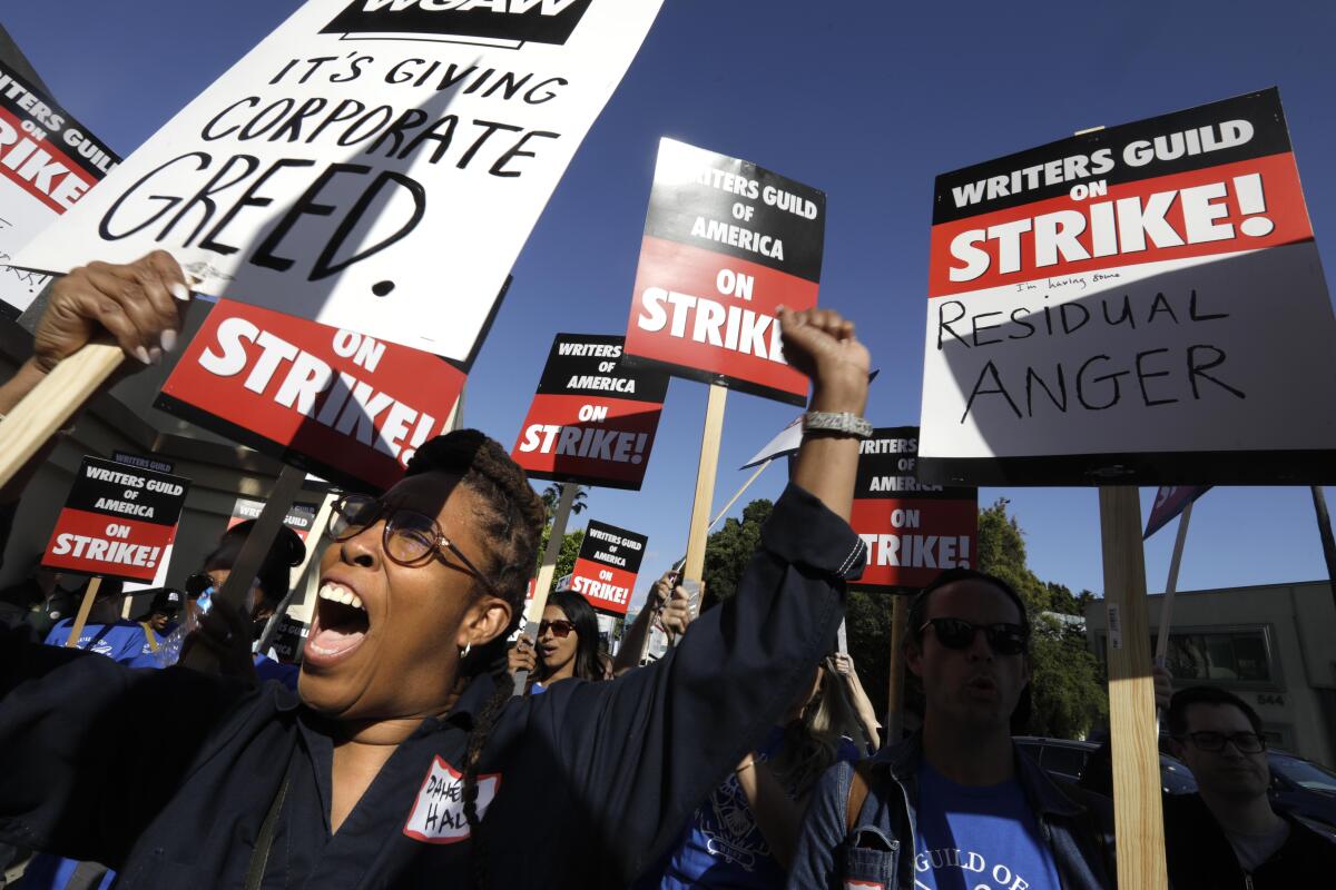 WGA members picket and shout on the first day of their strike in Hollywood on May 2.