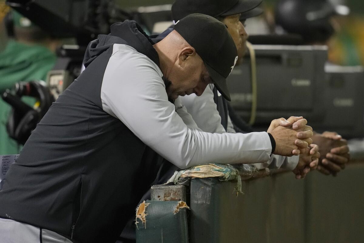 White Sox manager Pedro Grifol looks down in the dugout during a game against the Athletics