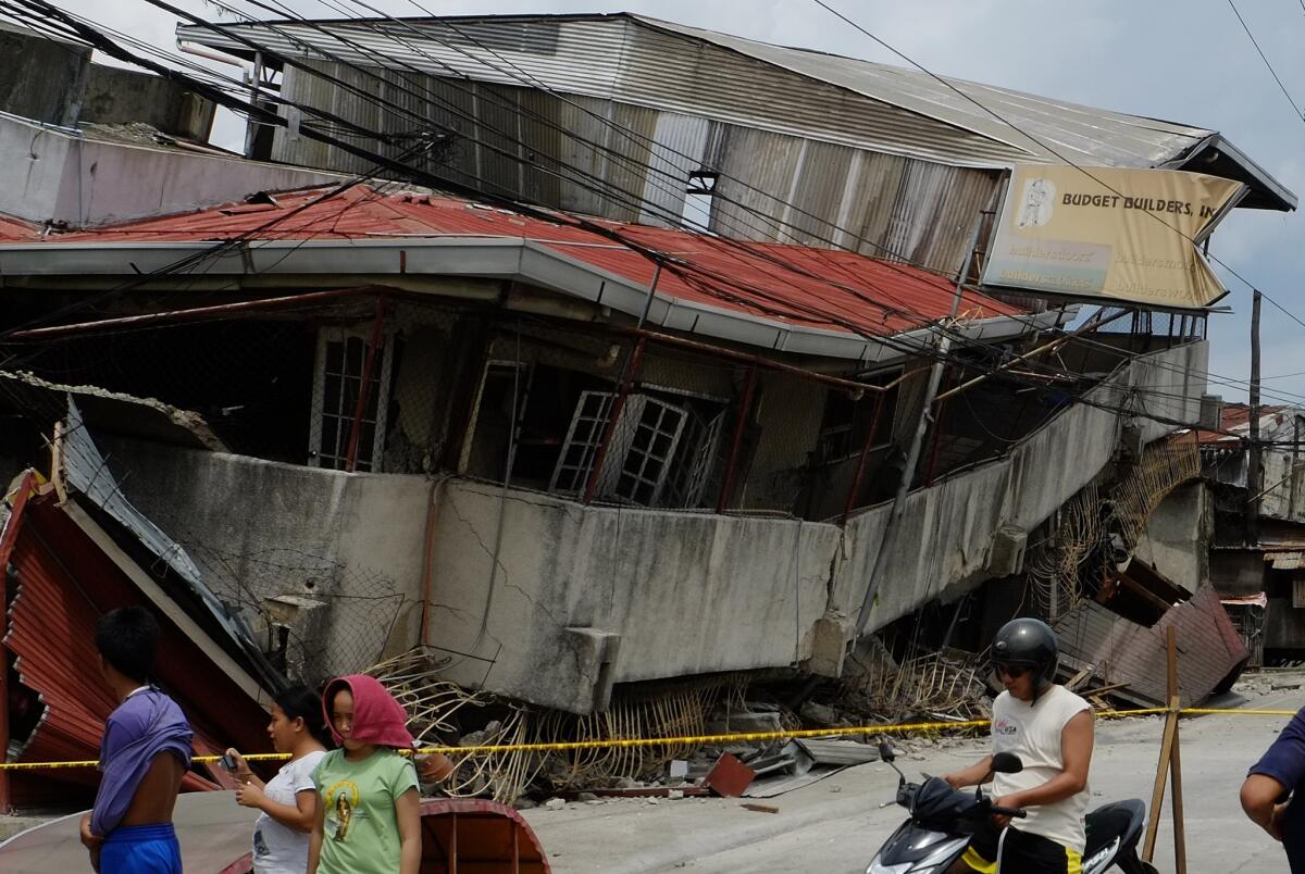 A building lies collapsed in Cebu, central Philippines, on Oct. 15, 2013., after a magnitude 7.2 earthquake struck.