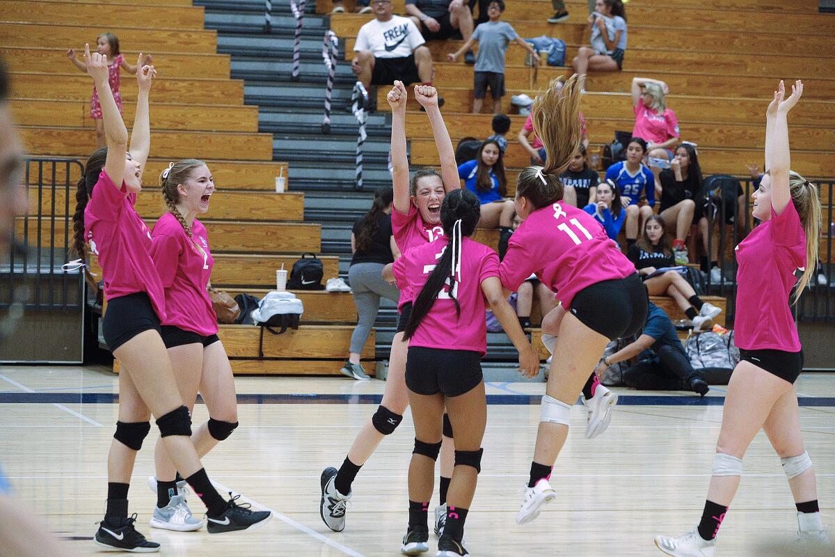 The Crescenta Valley High girls' volleyball team celebrates a point against Burbank during Thursday's home Pacific League match.