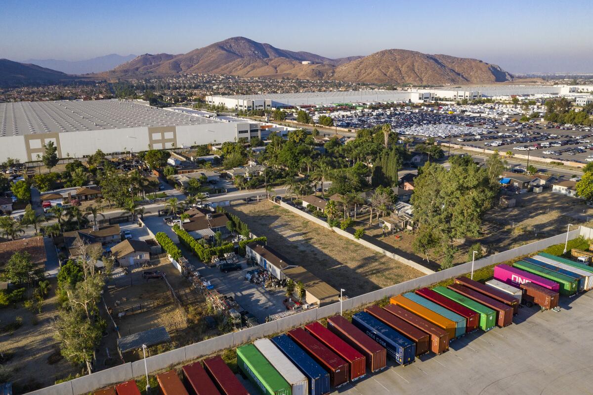 An aerial view of warehouses and multicolored storage units in Fontana.