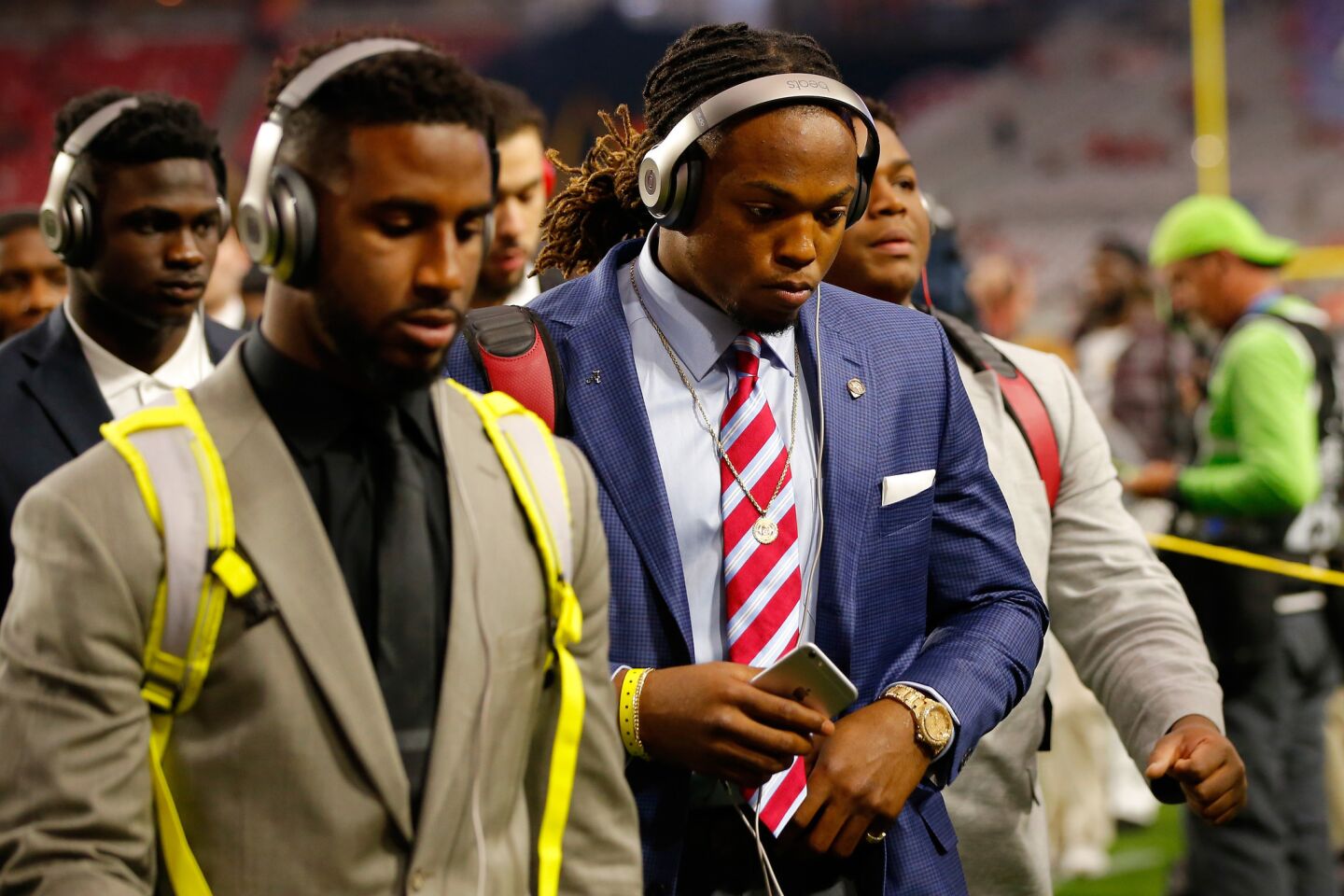 Alabama running back and Heisman Trophy winner Derrick Henry, right, walks on to the field before the start of the 2016 College Football Playoff championship game against Clemson.