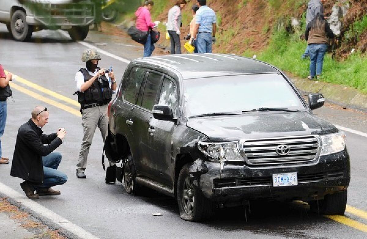 Investigators check a U.S. diplomatic vehicle attacked by Mexican federal police south of Mexico City. President Felipe Calderon had vowed to create a trustworthy force, but many are scoffing at that idea.