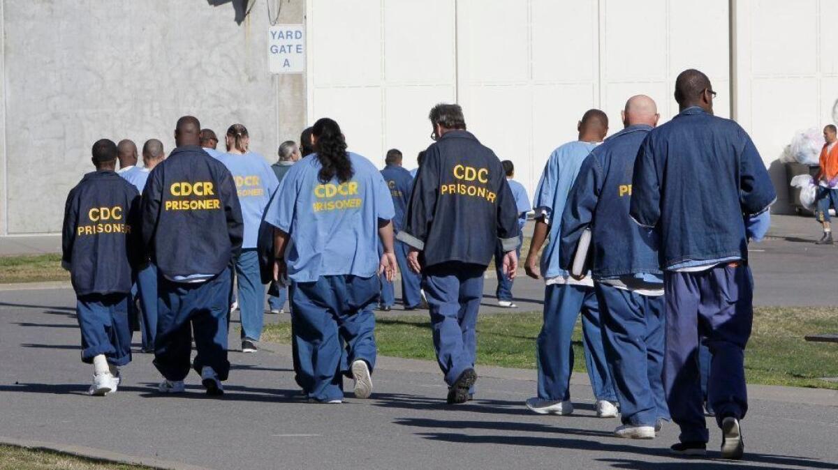 Inmates walk through the exercise yard at California State Prison Sacramento near Folsom in 2013.