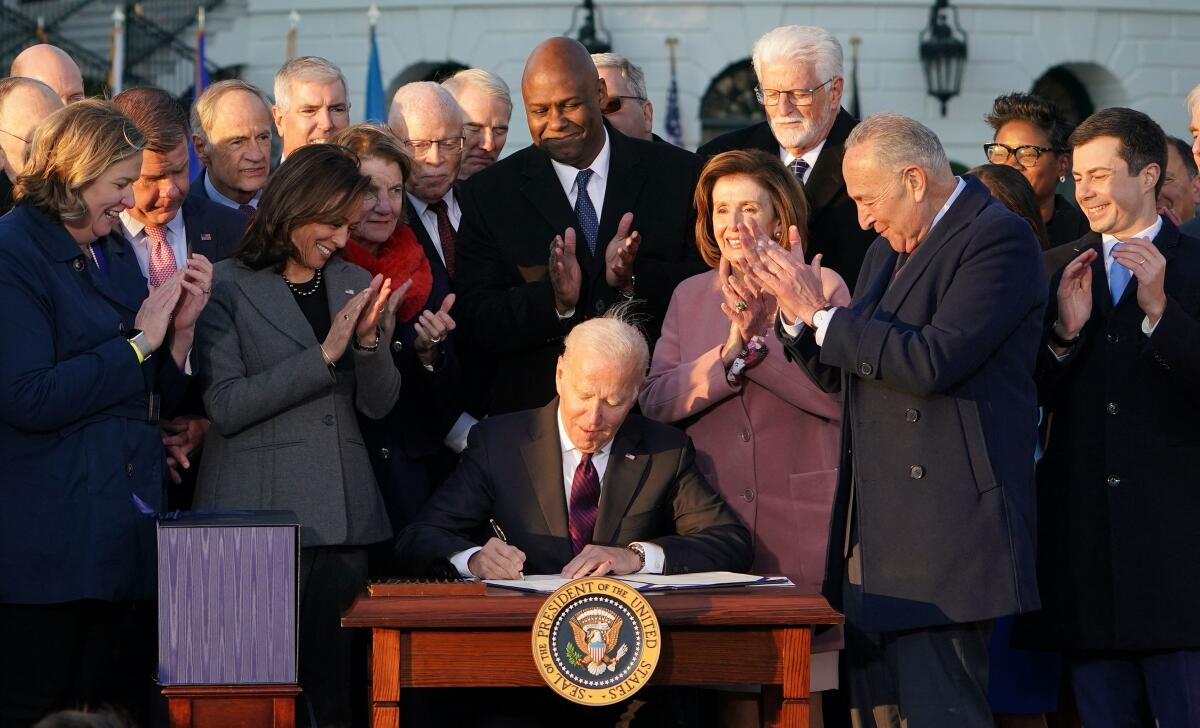 President Biden signs the Infrastructure Investment and Jobs Act at the White House on Monday.