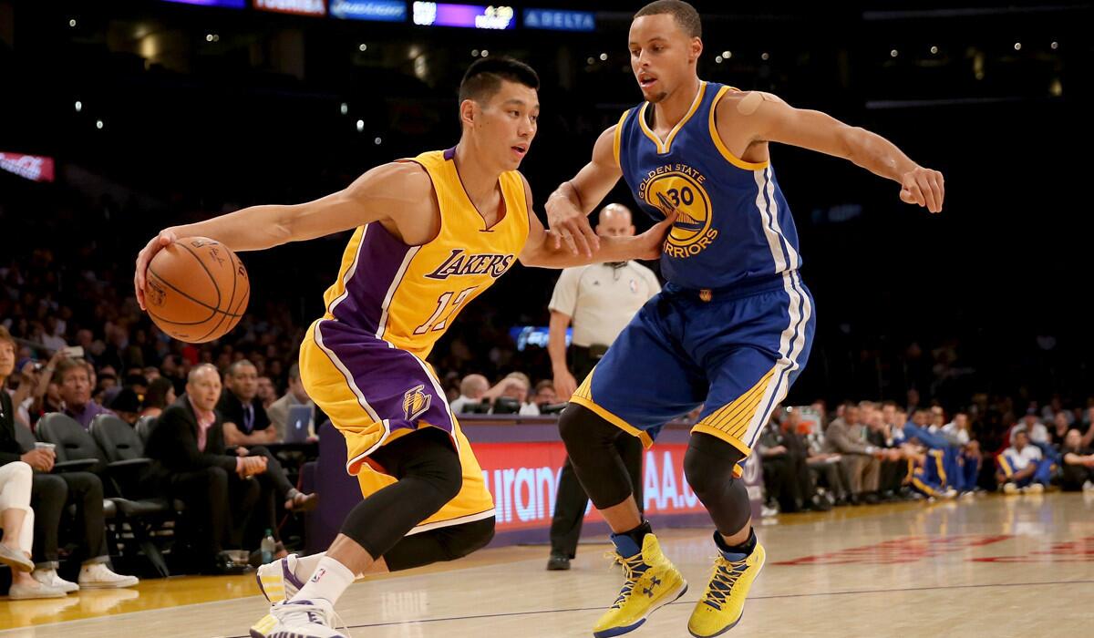 Lakers point guard Jeremy Lin looks to drive against Warriors point guard Stephen Curry during an exhibition game Oct. 9 at Staples Center.