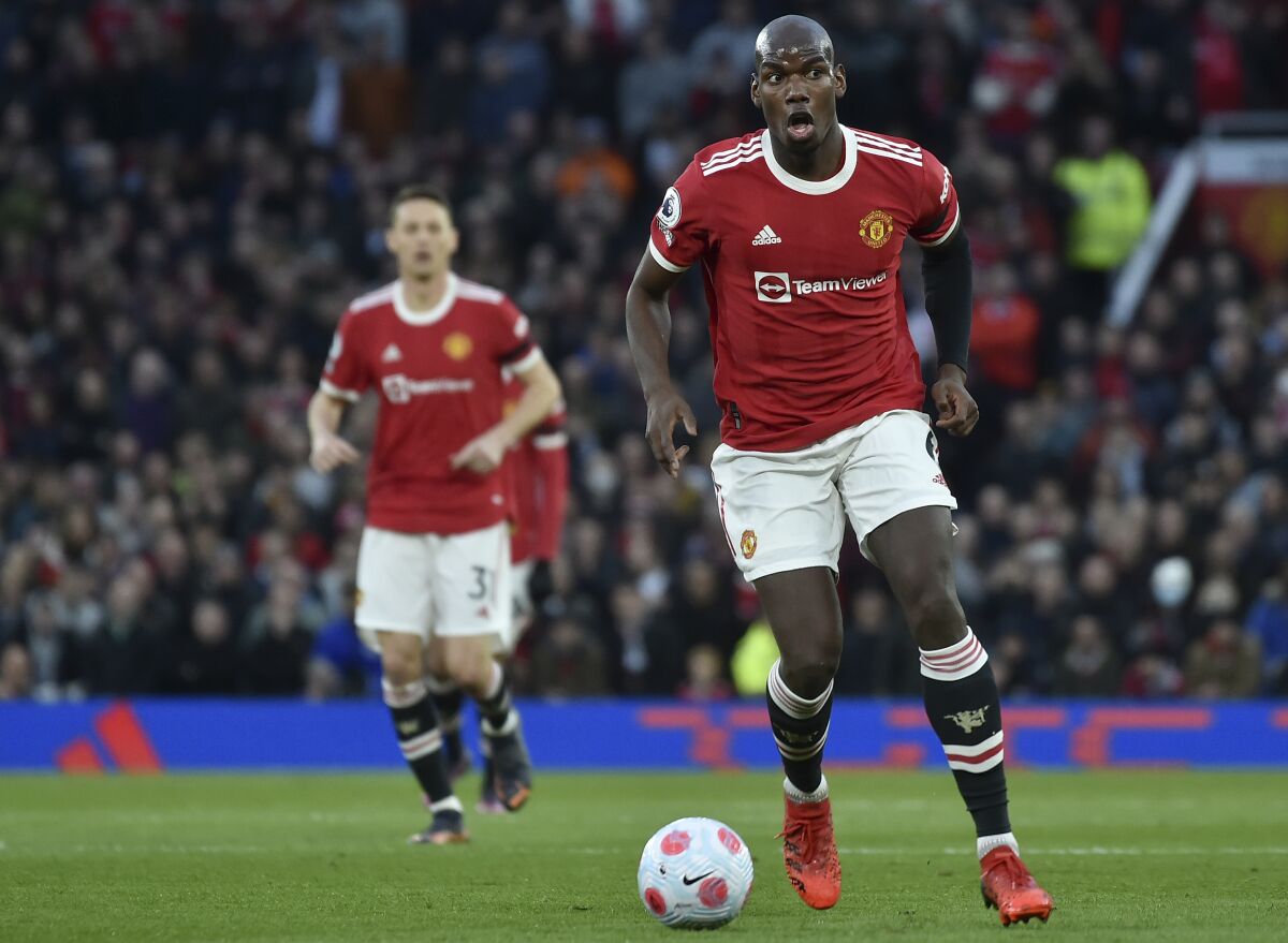 Manchester United's Paul Pogba controls the ball during the English Premier League soccer match between Manchester United and Tottenham Hotspur, at the Old Trafford stadium in Manchester, England, Saturday, March 12, 2022. (AP Photo/Rui Vieira)