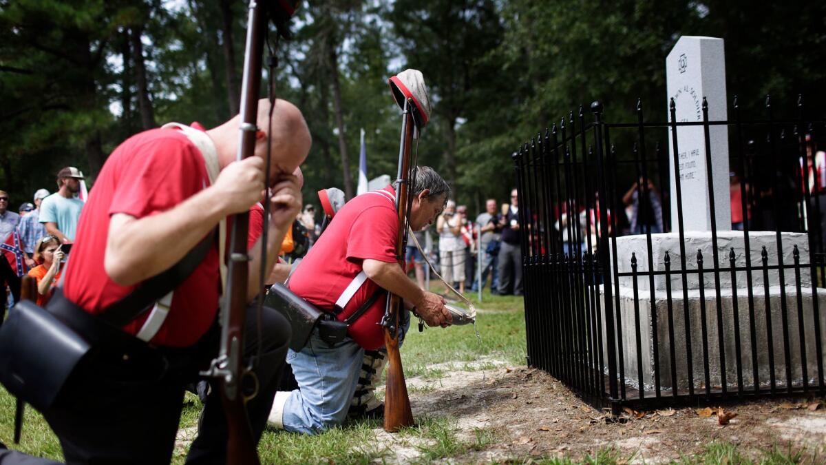 Members of the Sons of Confederate Veterans kneel Aug. 27 in front of a new monument called the "Unknown Alabama Confederate Soldiers" in Brantley, Ala.