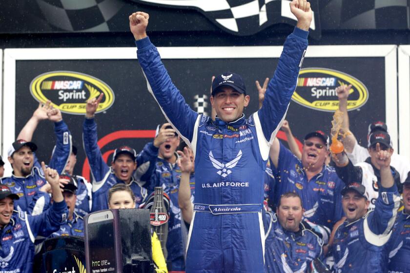 Aric Almirola celebrates in Victory Lane after winning the NASCAR Sprint Cup Series Coke Zero 400 on Sunday at Daytona International Speedway.