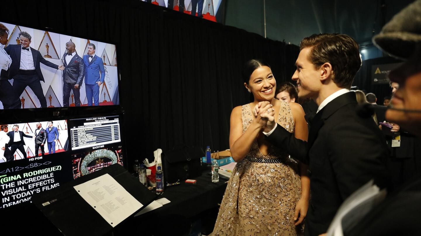 Gina Rodriguez and Tom Holland backstage at the 90th Academy Awards on Sunday at the Dolby Theatre in Hollywood.