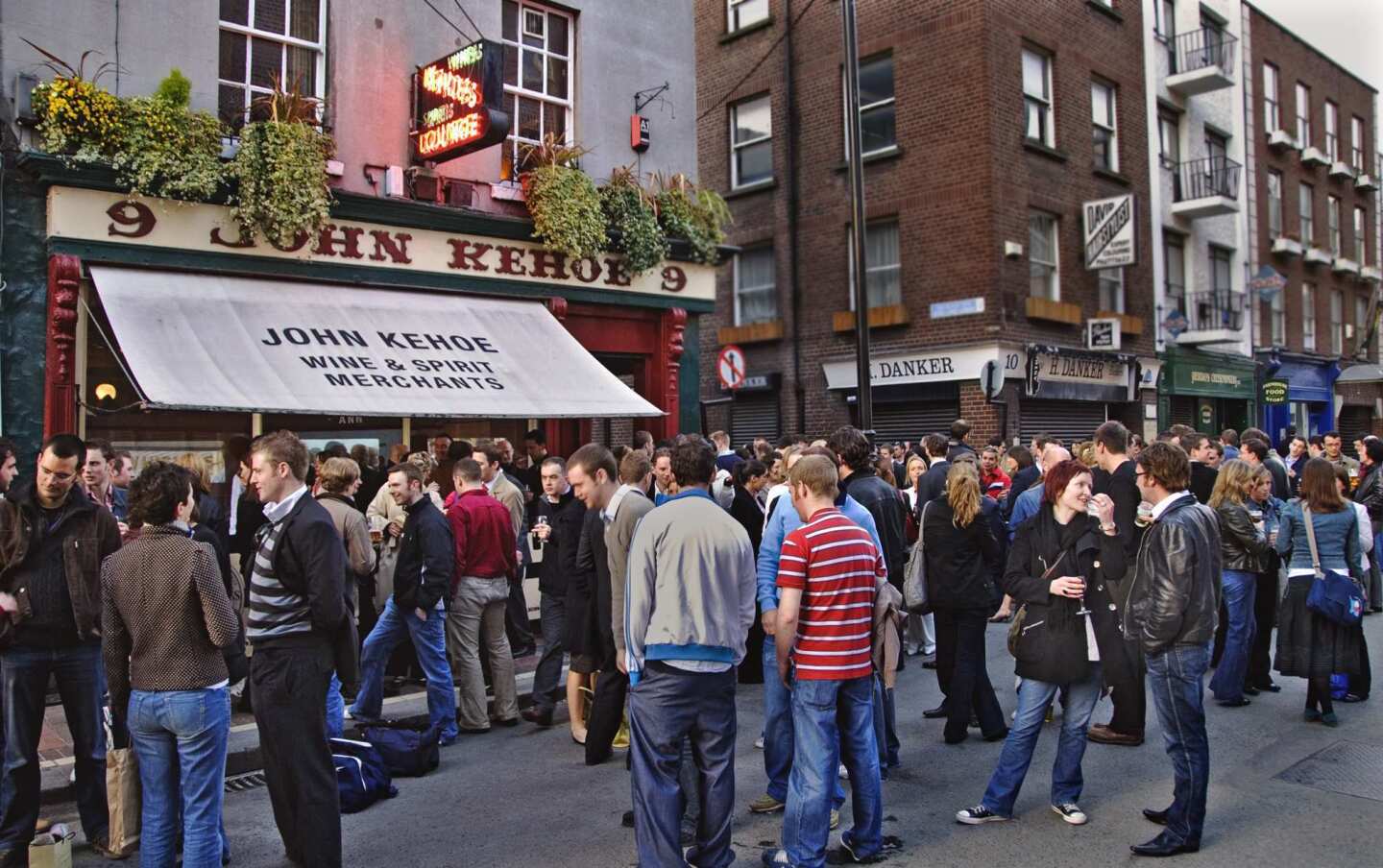 People drink on Grafton Street after work outside of John Kehoe, a very popular pub that often draws a crowd that spills out to the street.