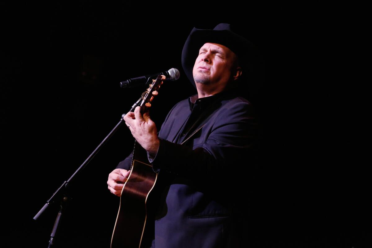 Garth Brooks, shown performing at the ASCAP Centennial Awards in November in New York City, is saluted by Staten Island's PS22 Chorus with a YouTube performance of his recent single "People Loving People."