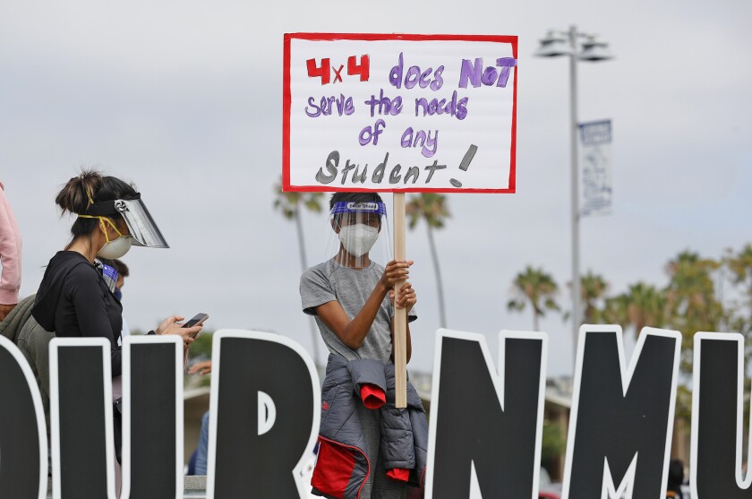 A student stands in front of Corona del Mar High School.