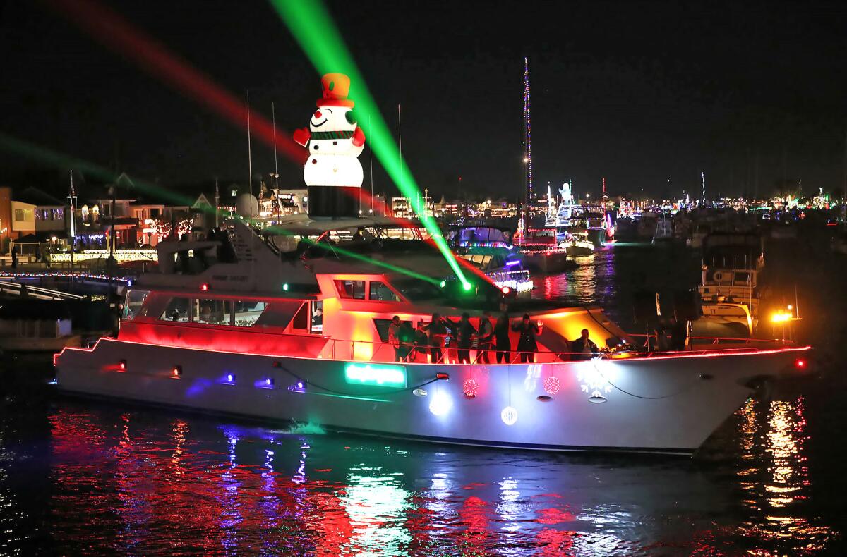 A boat turns at the Balboa Island Bridge on opening night of the 115th Annual Newport Beach Christmas Boat Parade Wednesday.