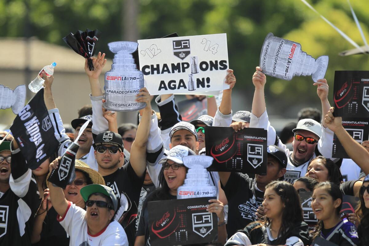 Thousands of Kings fans wait to see the Kings players celebrate their Stanley Cup win as they parade through downtown L.A. on Monday.