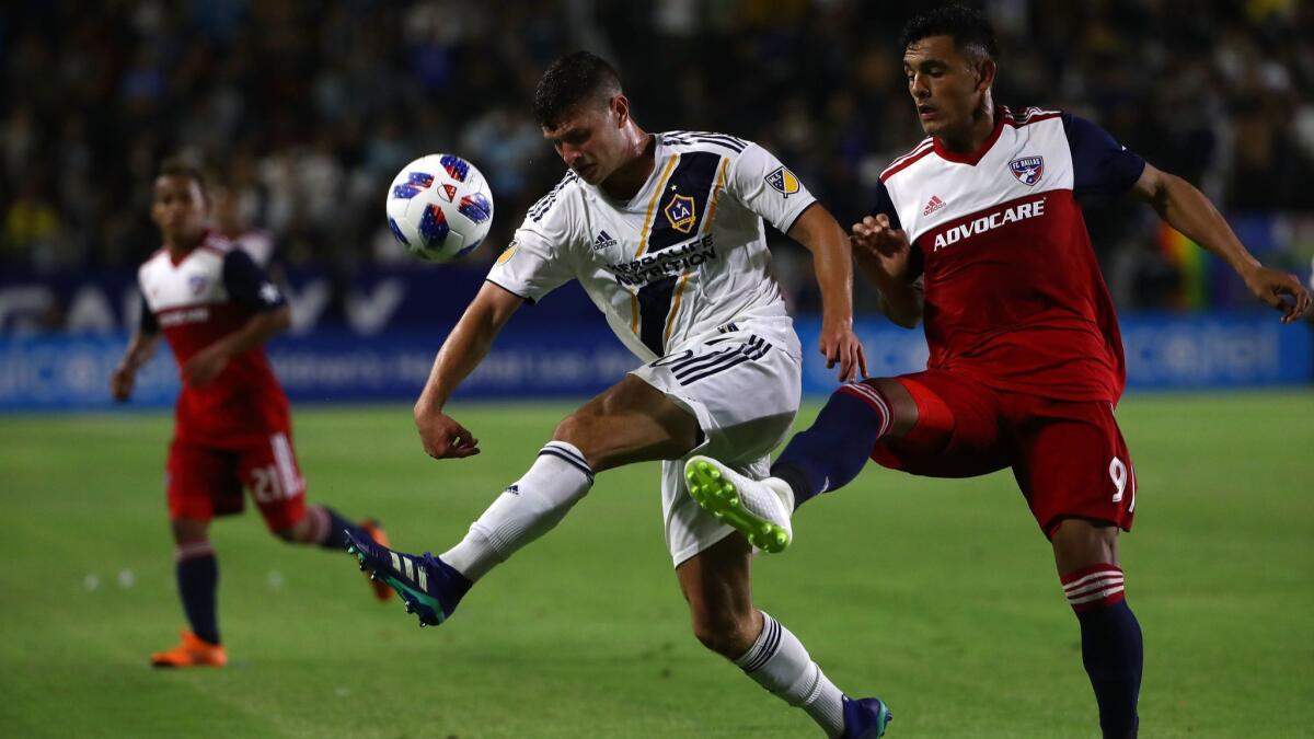 Tomas Hilliard-Arce and Cristian Colman of FC Dallas vie for the ball.