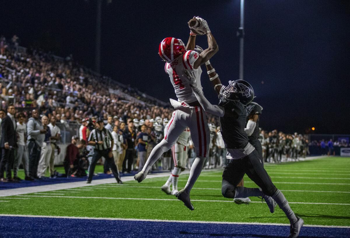 Receiver Kody Epps of Mater Dei catches a pass for a touchdown over Josh Alford of St. John Bosco. Both schools are in the Division 1 semifinals.