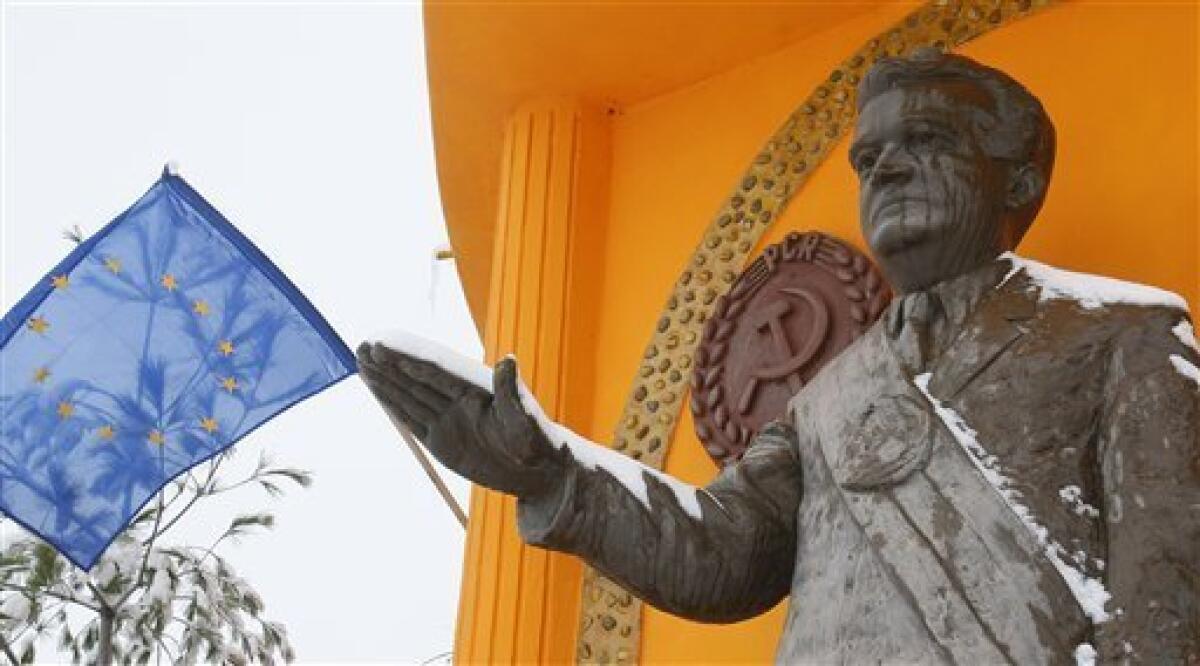 In this picture taken on Dec. 15, 2009, the bust of communist dictator Nicolae Ceausescu is seen next to the European Union flag in Podari, southern Romania. This week Romanians commemorate 20 years since communist dictator Nicolae Ceausescu fled Bucharest during a popular uprising on Dec. 22, 1989, after ruling Romania for 25 years. Ceausescu was executed together with his wife Elena on Dec. 25, 1989.More than a thousand people are reported to have lost their lives during the Romanian revolution.(AP Photo/Vadim Ghirda)