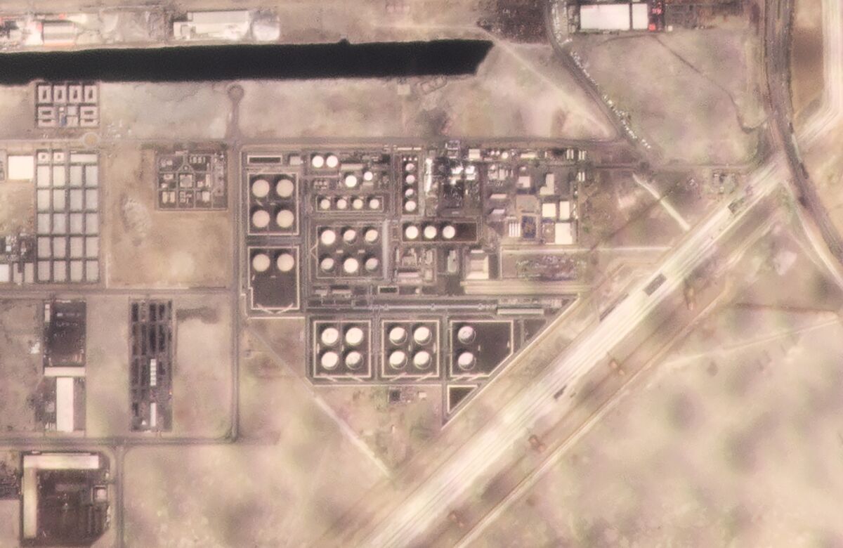 In this satellite image provided by Planet Labs PBC, white fire suppressing foam is seen after an attack on an Abu Dhabi National Oil Co. fuel depot in the Mussafah neighborhood of Abu Dhabi, United Arab Emirates, Monday, Jan. 17, 2022. A drone attack claimed by Yemen's Houthi rebels targeting a key oil facility in Abu Dhabi killed three people on Monday and sparked a fire at Abu Dhabi's international airport. (Planet Labs PBC via AP)