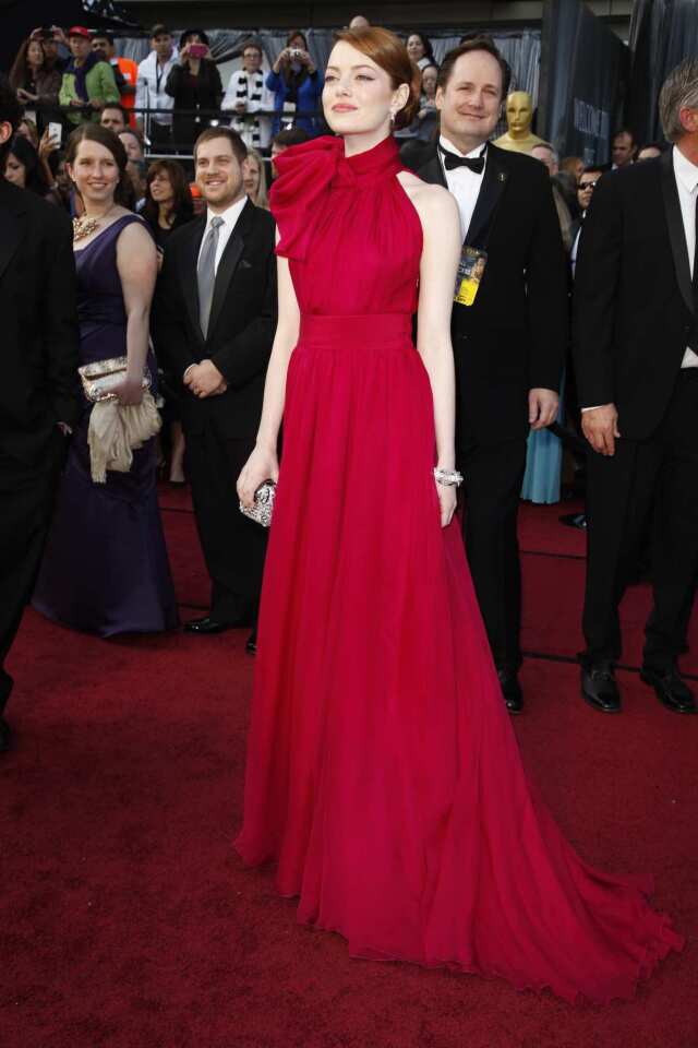 The giant red bow at the neck of Emma Stone's cherry red Giambattista Valli gown was an appropriately festive, bold statement for the occasion. A joy to look at.