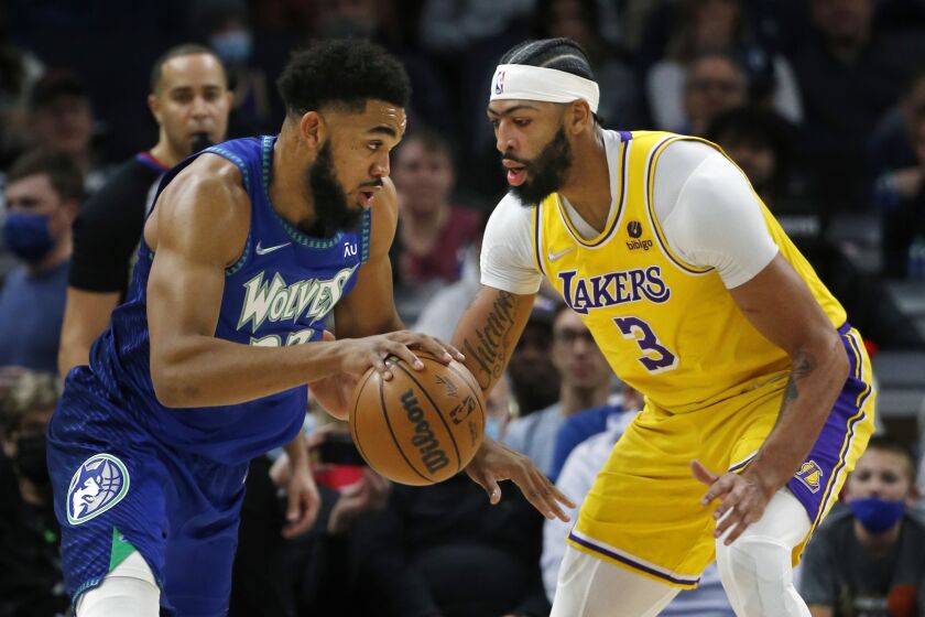 The Timberwolves' Karl-Anthony Towns, left, works against the Lakers' Anthony Davis on Dec. 17, 2021.