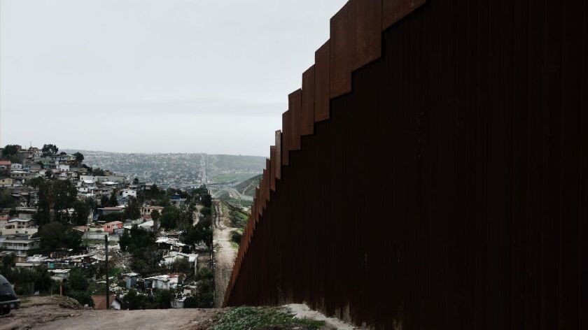 U.S. border fencing runs alongside the Mexican city of Tijuana.