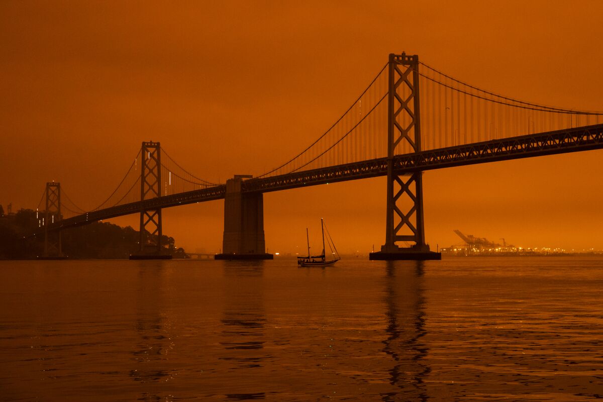 A ship passes beneath the Bay Bridge as smoke from Northern California wildfires blanketed San Francisco in early September.