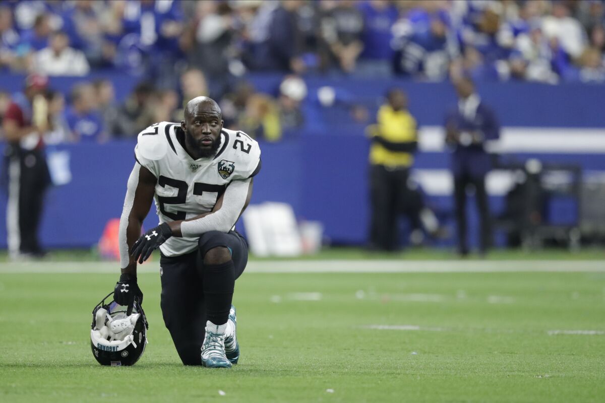 FILE - Jacksonville Jaguars' Leonard Fournette (27) kneels during the second half of an NFL football game against the Indianapolis Colts, Sunday, Nov. 17, 2019, in Indianapolis. The Jacksonville Jaguars have waived running back Leonard Fournette, a stunning decision that gets the team closer to purging Tom Coughlin's tenure.(AP Photo/Michael Conroy, File)