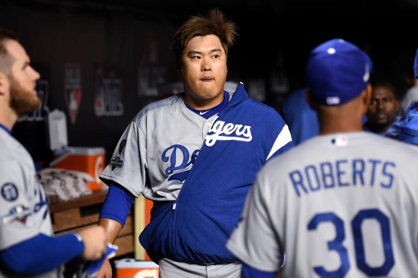 WASHINGTON D.C., OCTOBER 4, 2019-Dodgers pitcher Hyun-Jin Ryu walks in the dugout before Game 3 of the NLDS at Nationals Stadium Sunday. (Wally Skalij/Los Angeles Times)