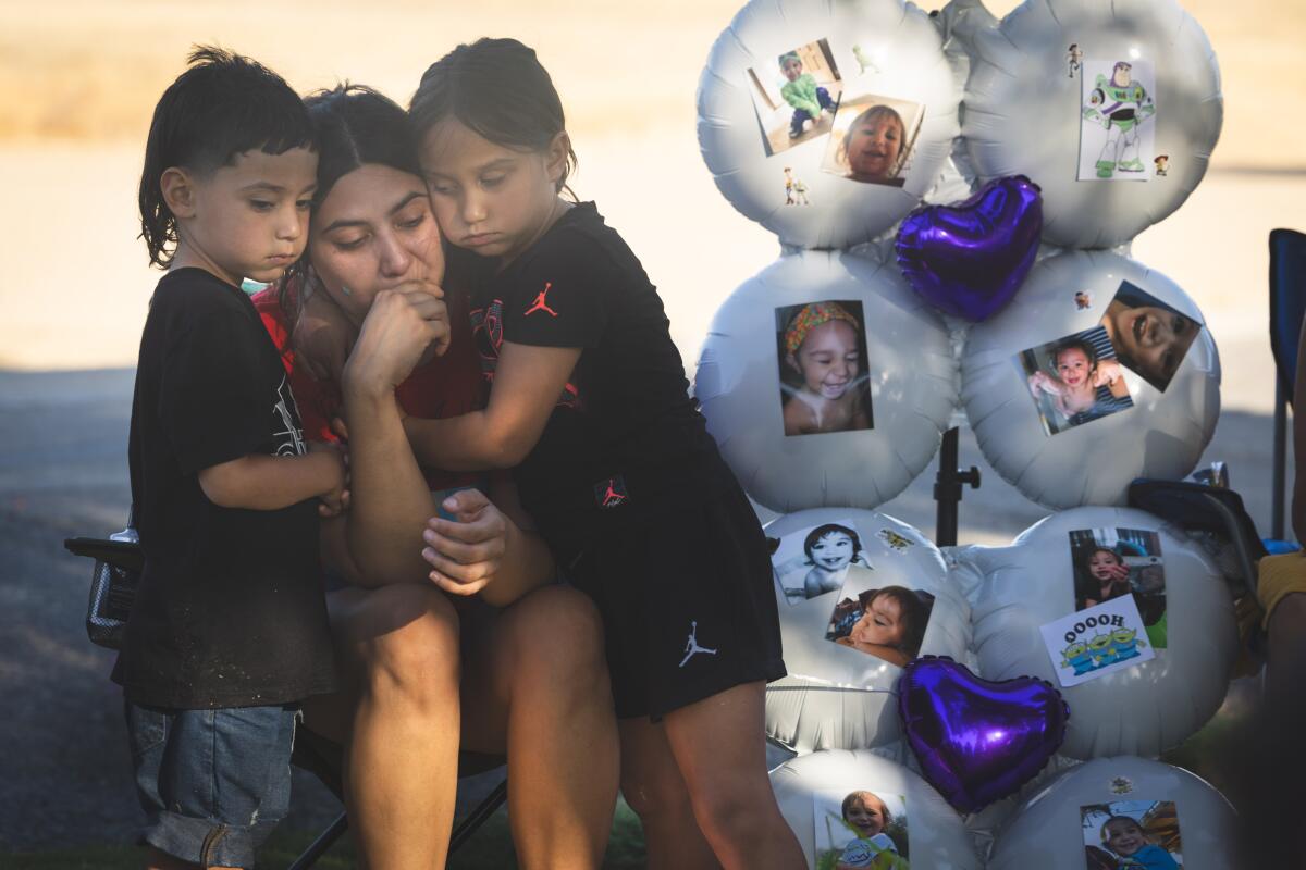 Soluna Lora and her children console each other after they unveiled the gravestone of her late son.