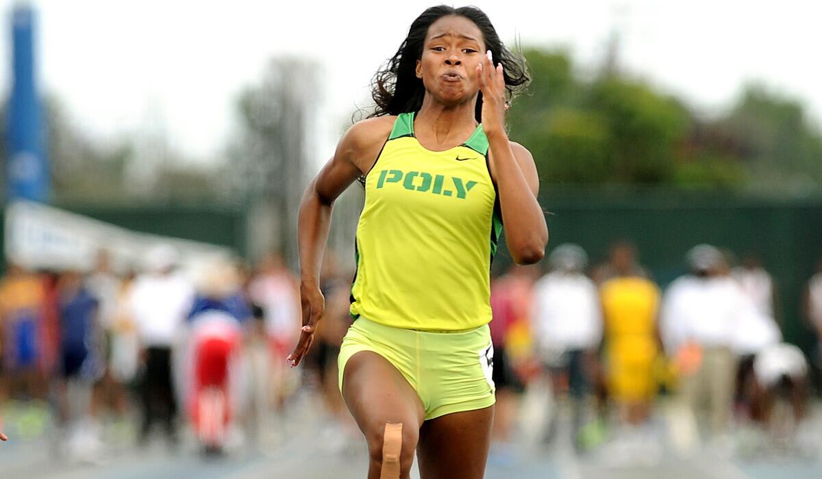 Long Beach Poly High's Ariana Washington, who won both sprints at the Masters meet and anchored the winning 4x100 relay, heads to the finish line at the Southern Section Division 1 finals last week.