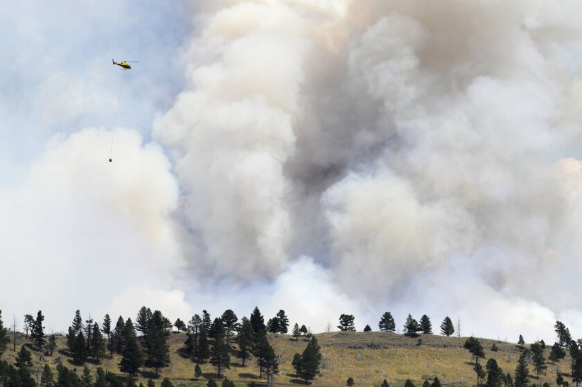 A helicopter approaches a wildfire near Townsend, Mont., on July 21.