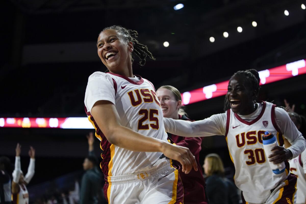 USC guard McKenzie Forbes reacts with guard Roxane Makolo after hitting a three-pointer against Cal Poly.