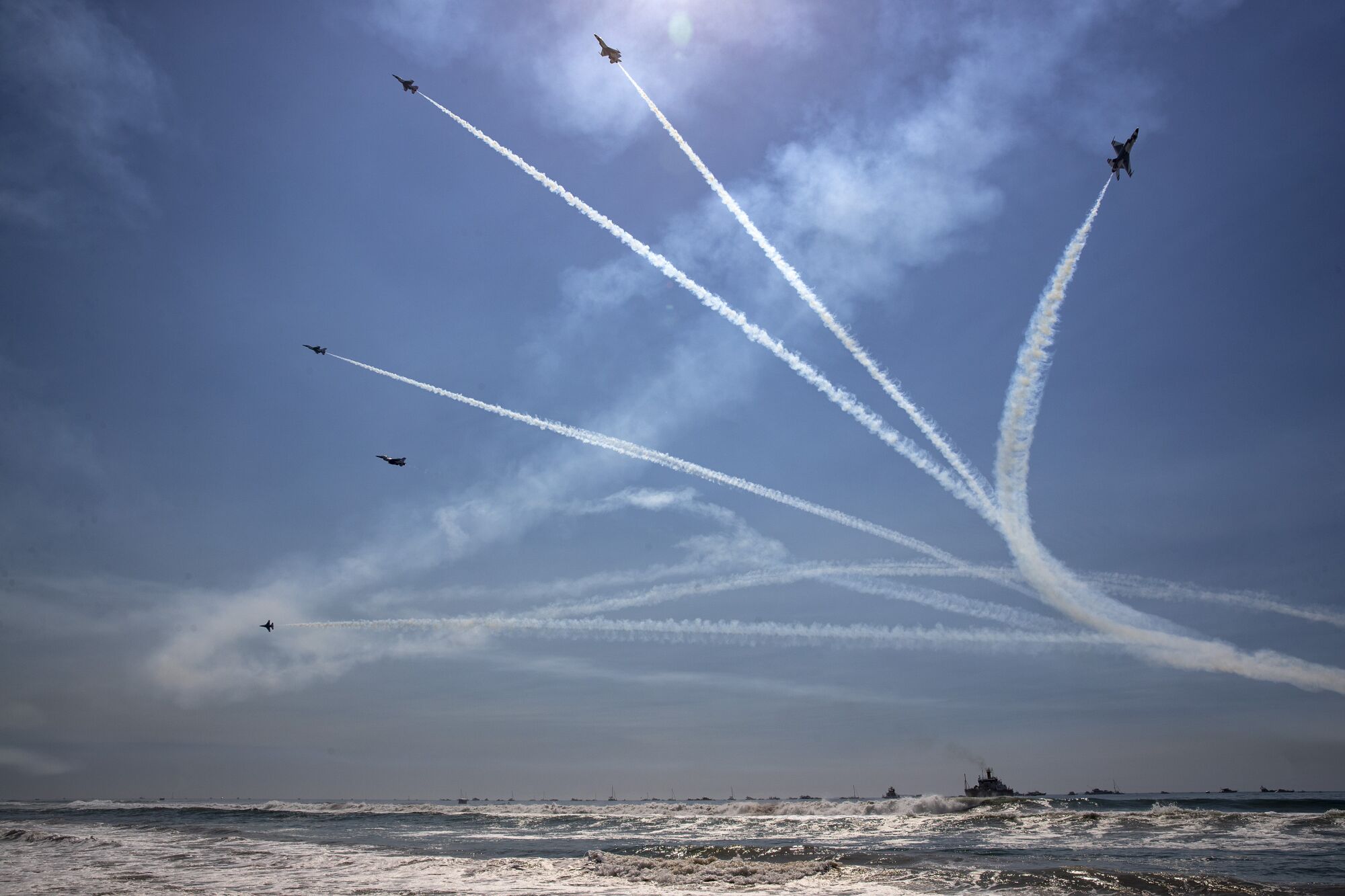  U.S. Air Force Thunderbirds break formation over the ocean