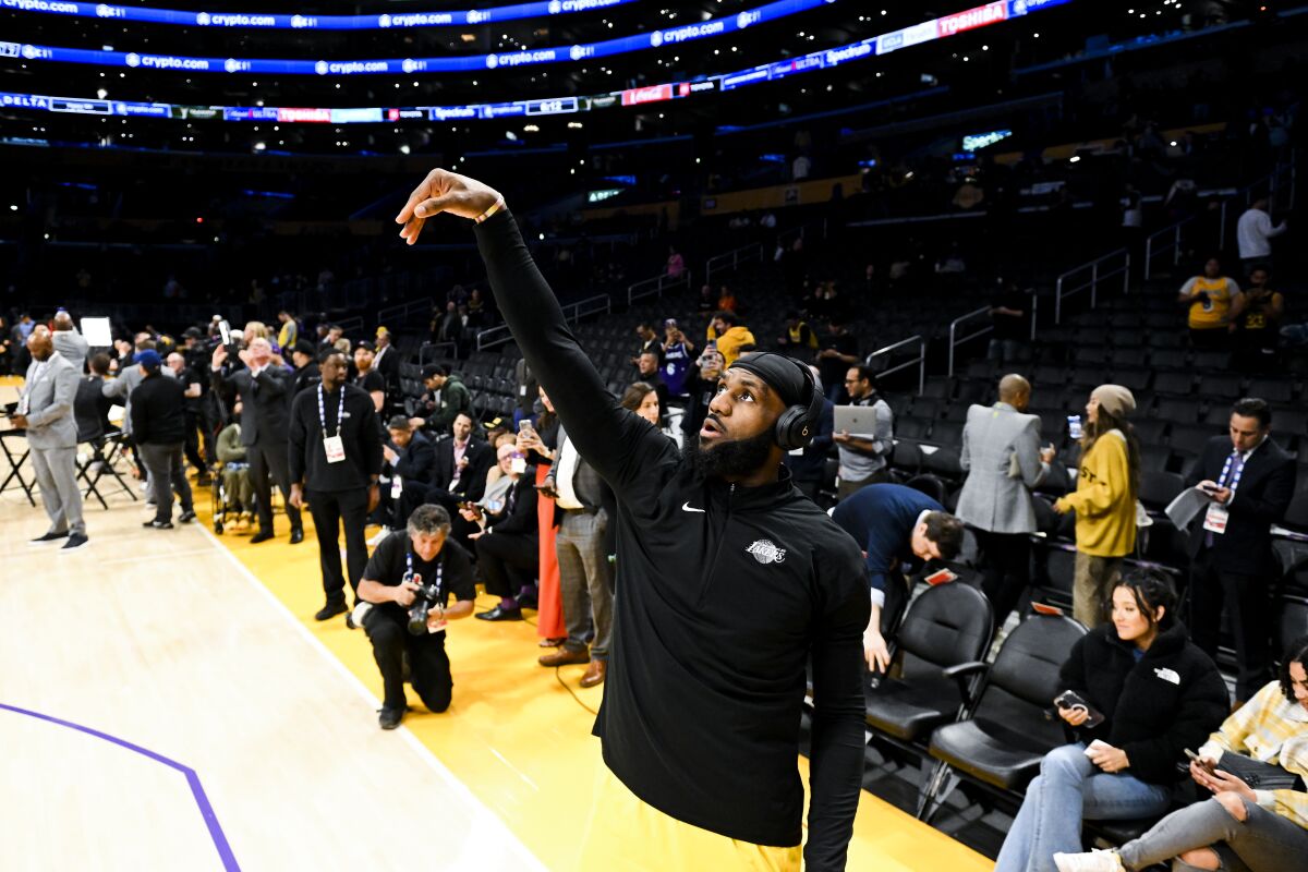 Lakers forward LeBron James follows through on his release during warmups before the game against the Thunder.