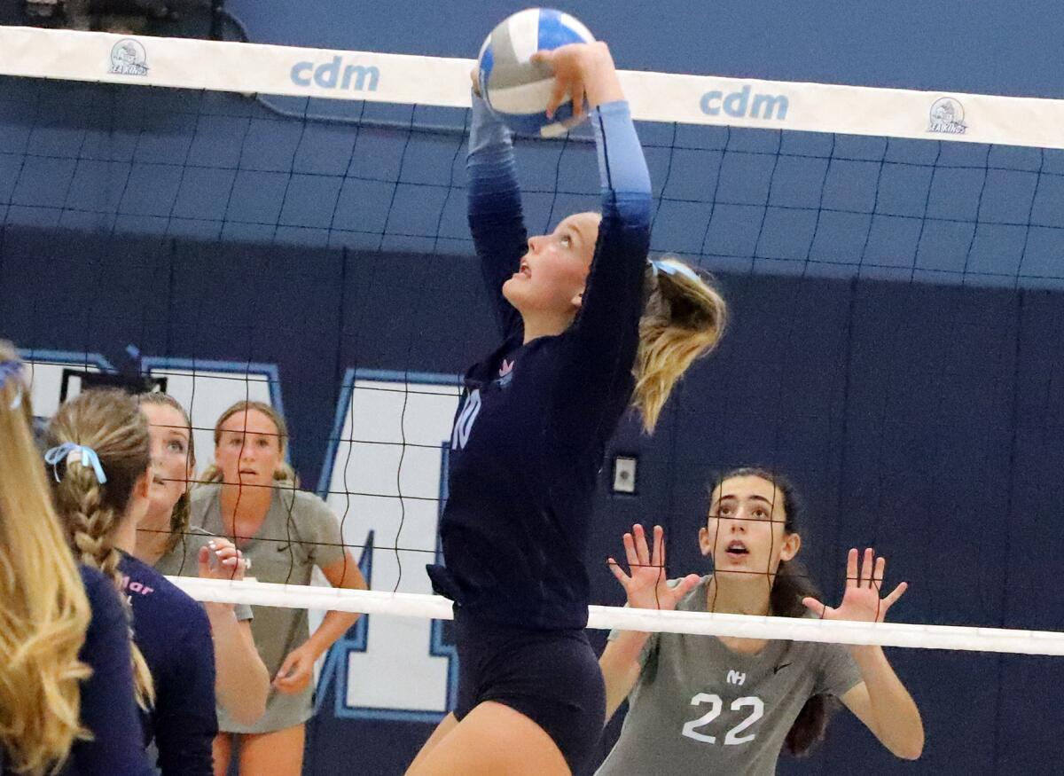 CdM's Eva Link (10) sets the ball against visiting Newport Harbor in the Battle of the Bay on Thursday.