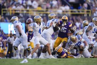 UCLA quarterback Ethan Garbers (4) passes in the second half of an NCAA college football game against LSU in Baton Rouge, La., Saturday, Sept. 21, 2024. LSU won 34-17. (AP Photo/Gerald Herbert)