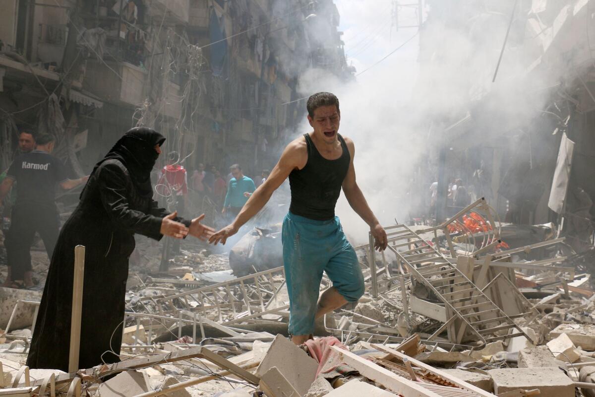 People walk amid the rubble after an airstrike on a rebel-held neighborhood in Aleppo, Syria.