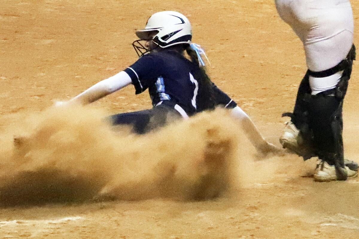 Marina's Liz Byer (7) slides safe at home against Poway in the Michelle Carew Classic on Friday.