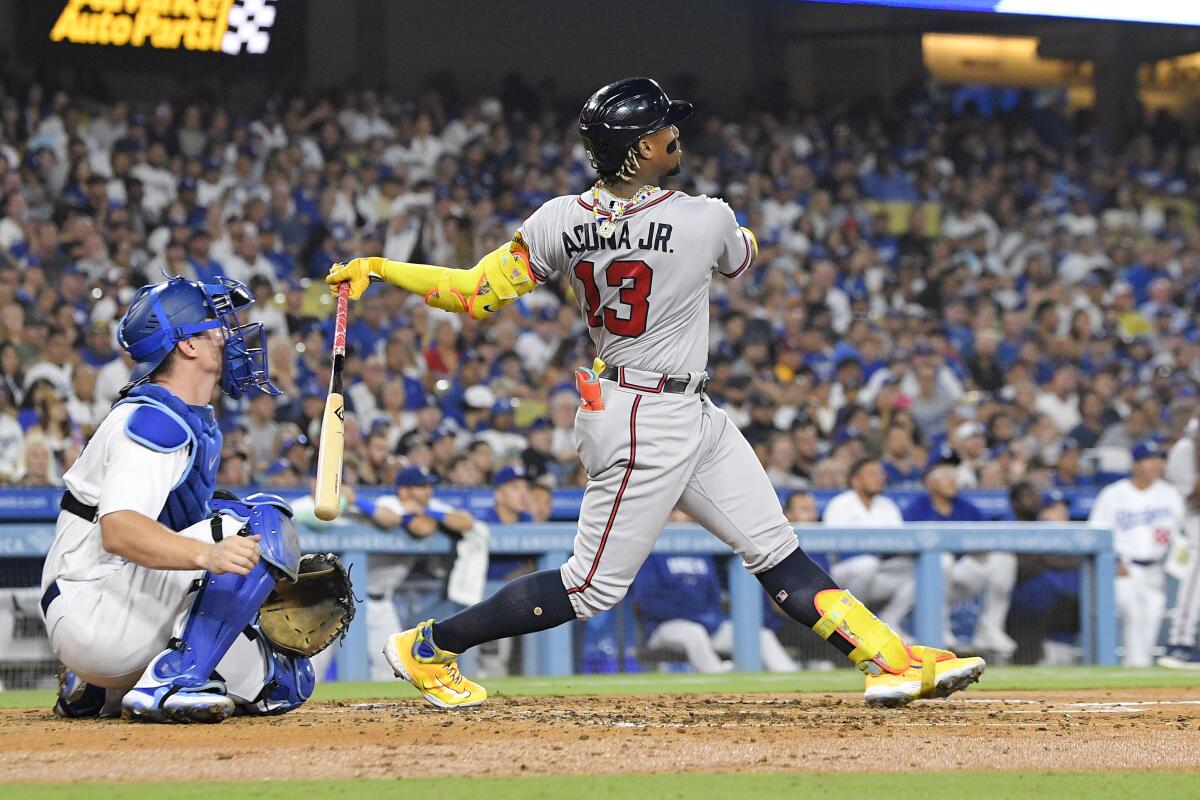 Atlanta Braves' Ronald Acuña Jr. hits a grand slam against the Dodgers on Aug. 31, 2023, at Dodger Stadium.