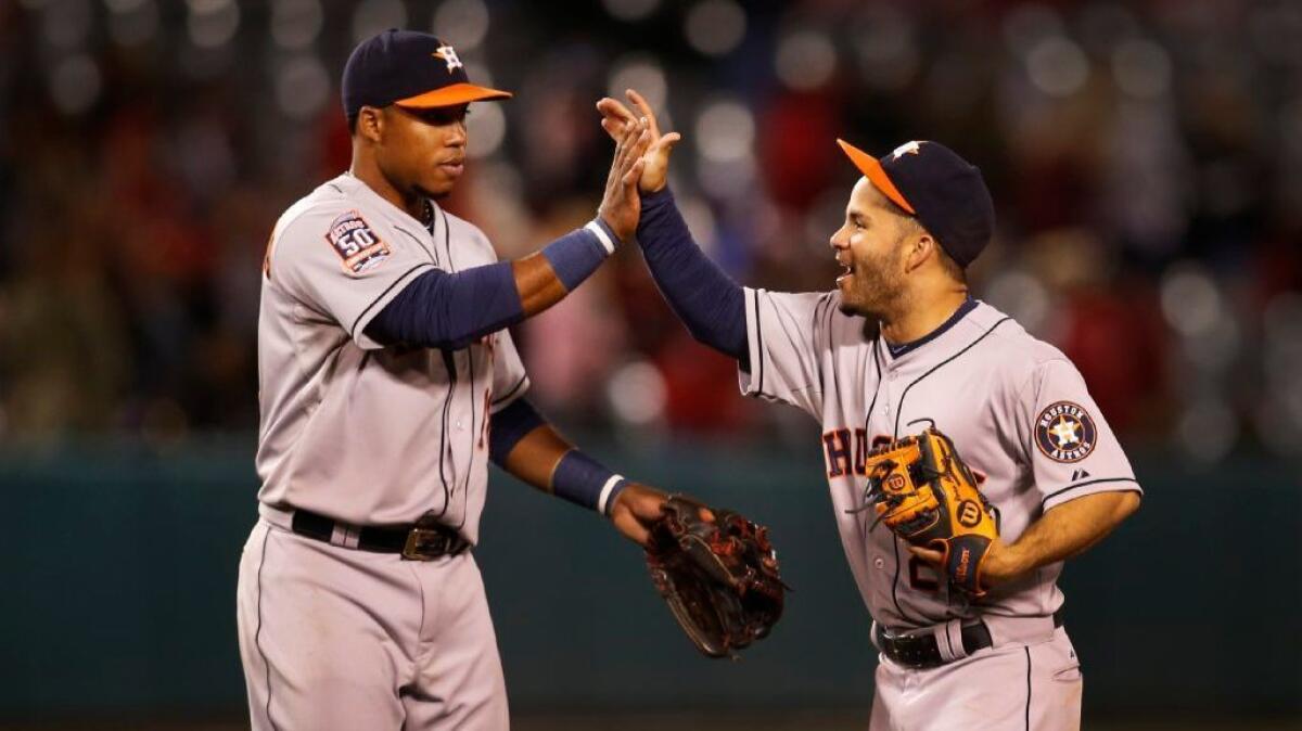 Luis Valbuena, left, greeting Jose Altuve after a game last season with the Houston Astros, is joining the Angels on a two-year deal.