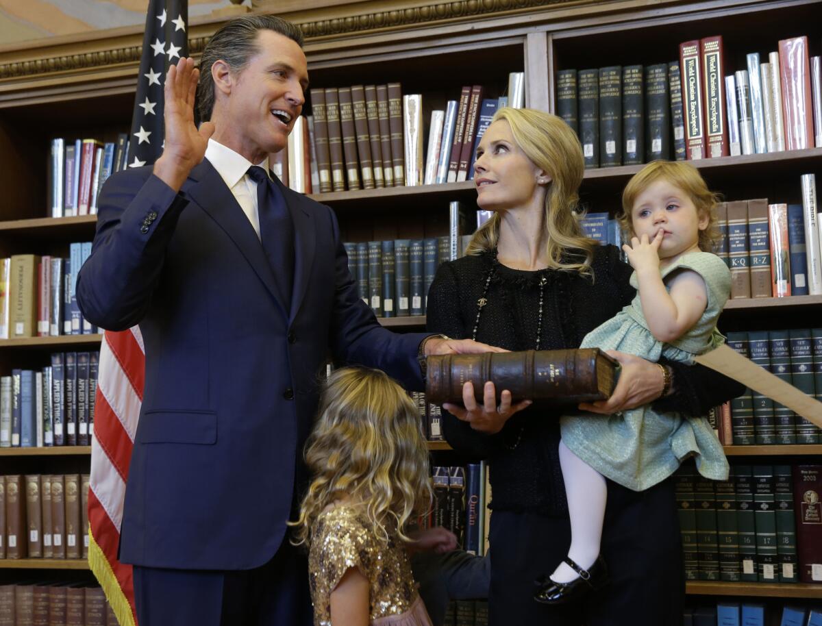 Lt. Gov. Gavin Newsom takes the oath of office for lieutenant governor on Jan. 5 with his wife, Jennifer, and daughters Brooklynn, 1, and Montana, 5.